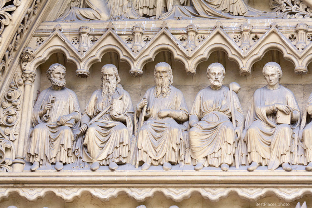 Westminster Abbey entrance sculptures sat down
